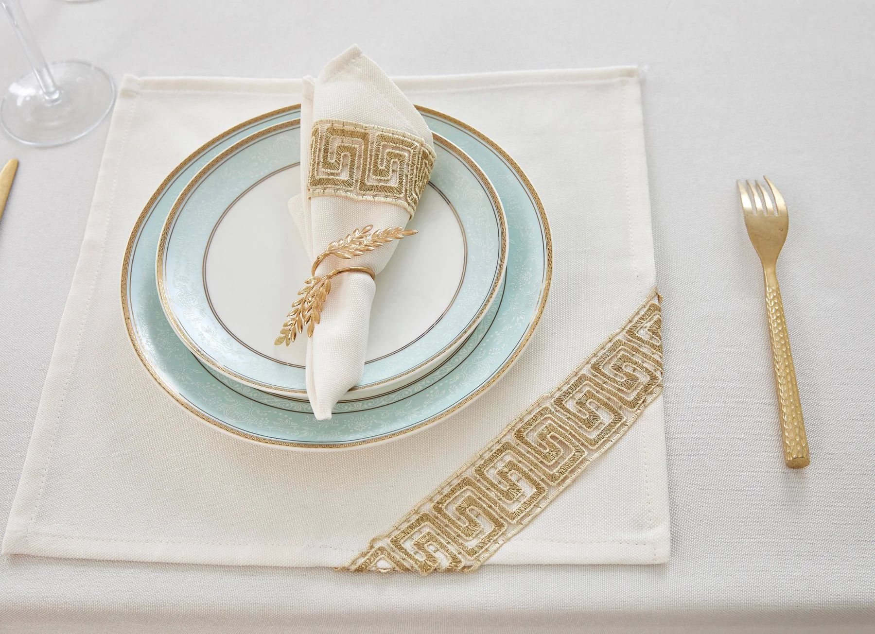 Folded dining napkin arranged with tableware