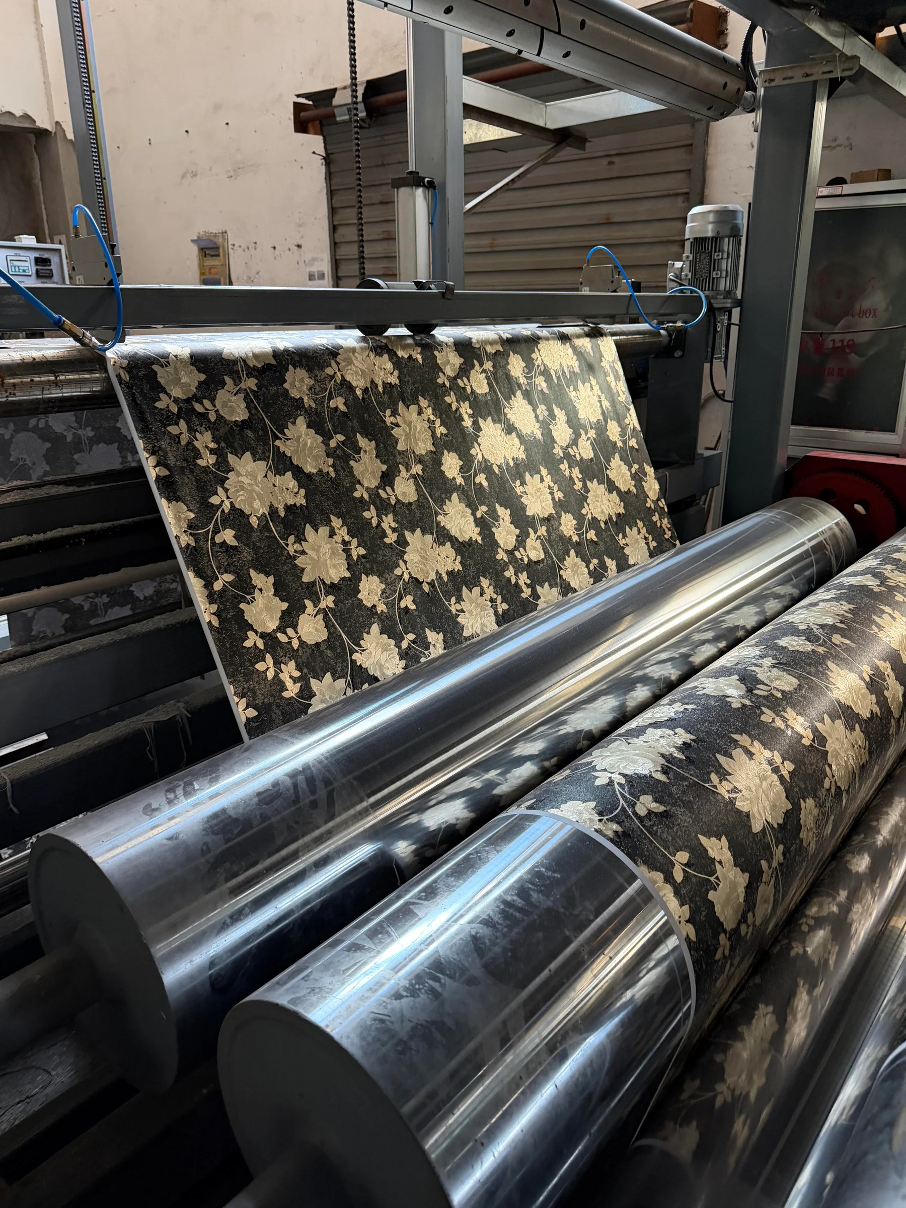 Textile lamination equipment processing patterned material in the Danli factory