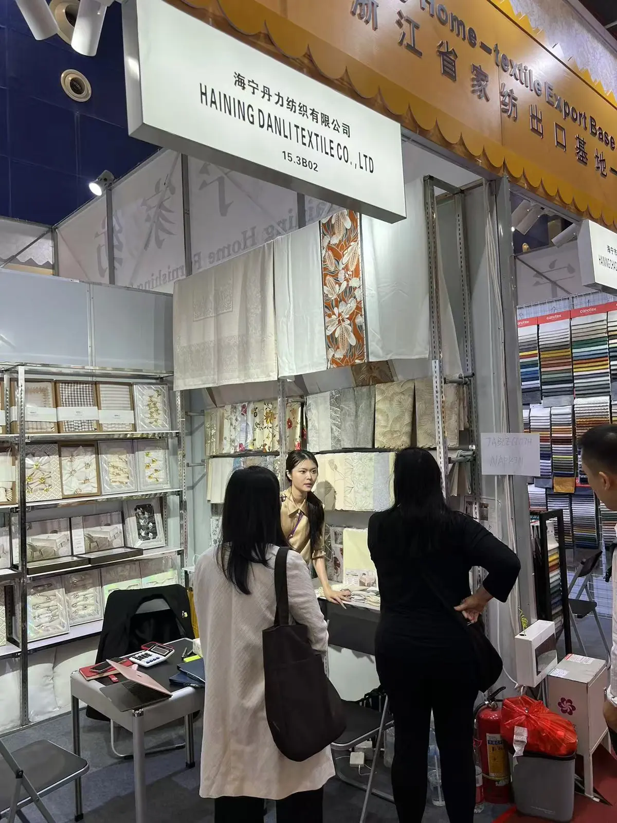 Danli representative presenting home textile products to visitors