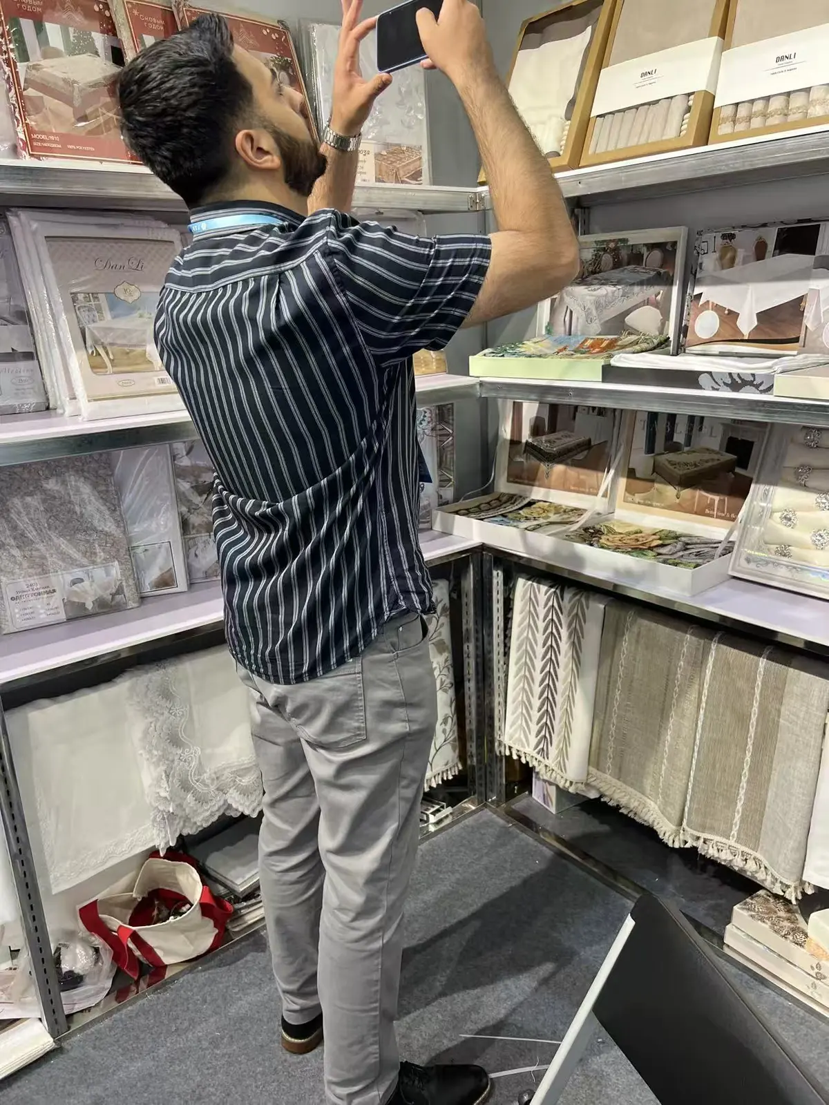 A visitor photographing Danli table linen products