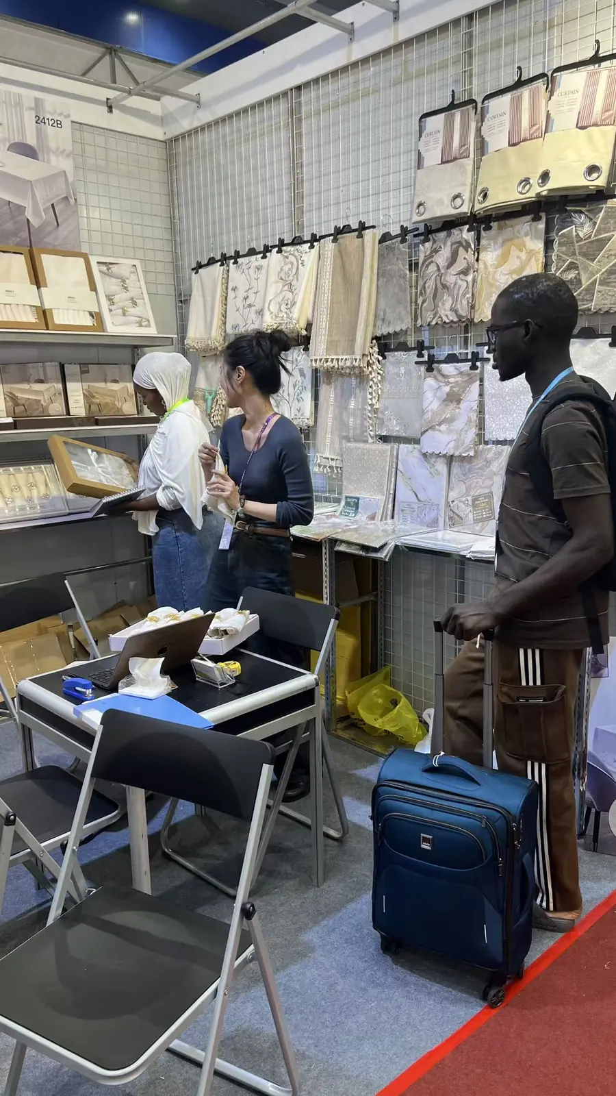 Visitors viewing table linen products at the Danli booth